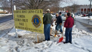 Fairfax Lions prepare signs advertising the March Sale